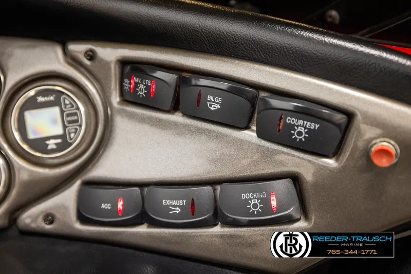 Slide: The Image of Dashboard controls of a 2005 Crownline 225 LPX boat, featuring various switches and buttons. - 28