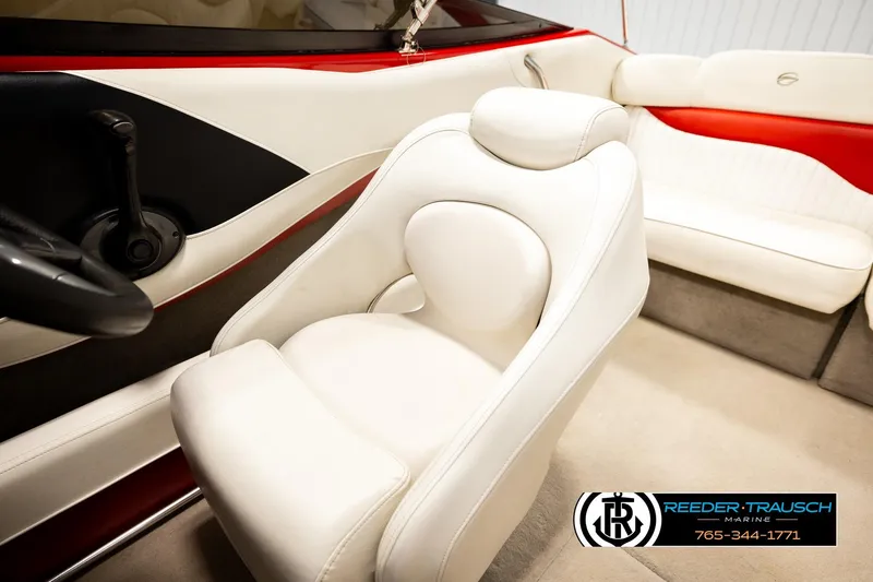 Slide: The Image of 2005 Crownline 225 LPX boat interior with white and red seating, steering wheel, and logo. - 31