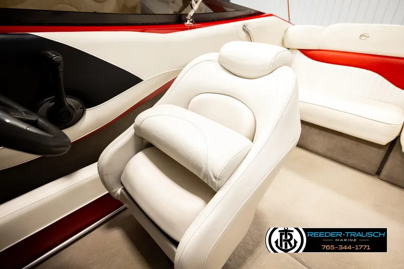 Slide: The Image of 2005 Crownline 225 LPX boat interior with white and red seating, steering wheel, and logo. - 32
