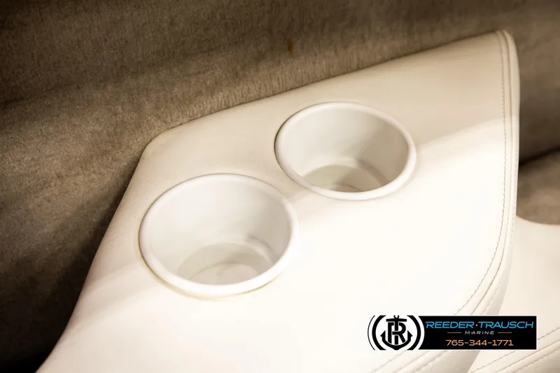 Slide: The Image of Cup holders in a 2005 Crownline 225 LPX boat interior, featuring white upholstery. - 37