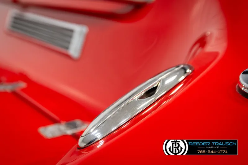 Slide: The Image of Close-up of a 2005 Crownline 225 LPX boat's sleek red exterior and chrome details. - 47