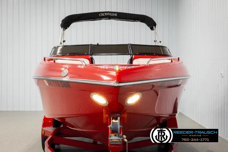 Slide: The Image of 2005 Crownline 225 LPX boat, red exterior, displayed indoors with trailer. - 8