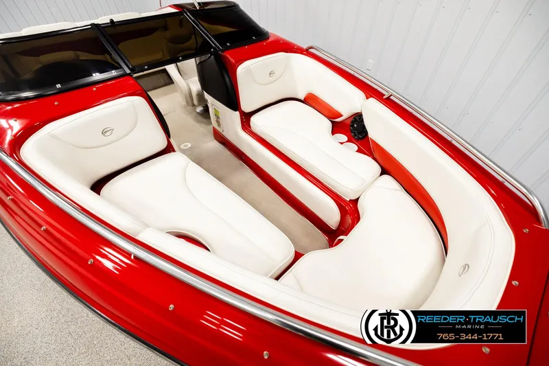 Slide: The Image of 2005 Crownline 225 LPX boat interior with red and white seating, Reeder-Trausch Marine logo. - 9