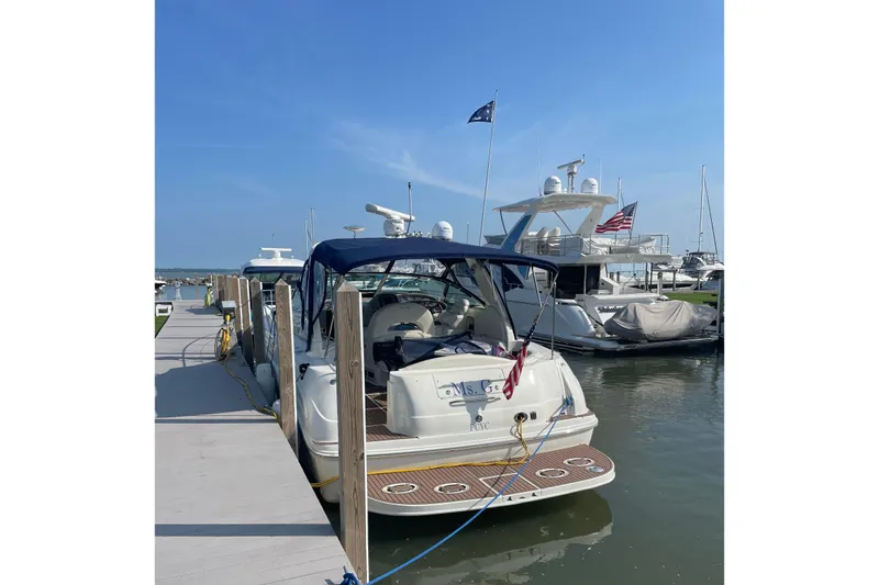 The Image of 2004 Sea Ray 380 Sundancer docked at marina under clear blue sky. - 0