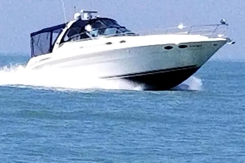 Slide: The Image of 2004 Sea Ray 380 Sundancer cruising on open water, showcasing sleek design and performance. - 1