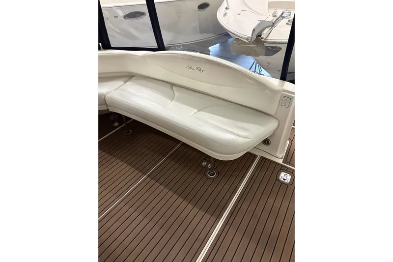 Slide: The Image of 2004 Sea Ray 380 Sundancer interior with white seating and wood-style flooring. - 14