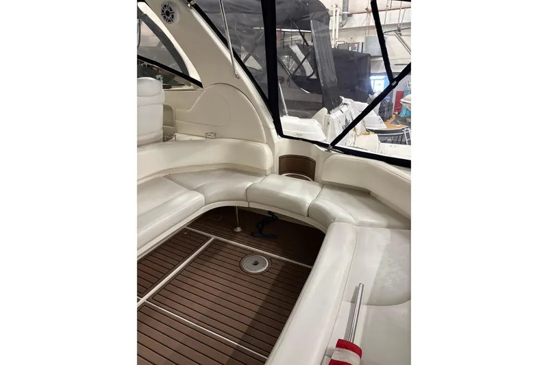 Slide: The Image of Interior of 2004 Sea Ray 380 Sundancer yacht with white seating and wooden flooring. - 15