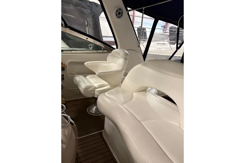 Slide: The Image of Interior of 2004 Sea Ray 380 Sundancer with white leather seating and wood flooring. - 16