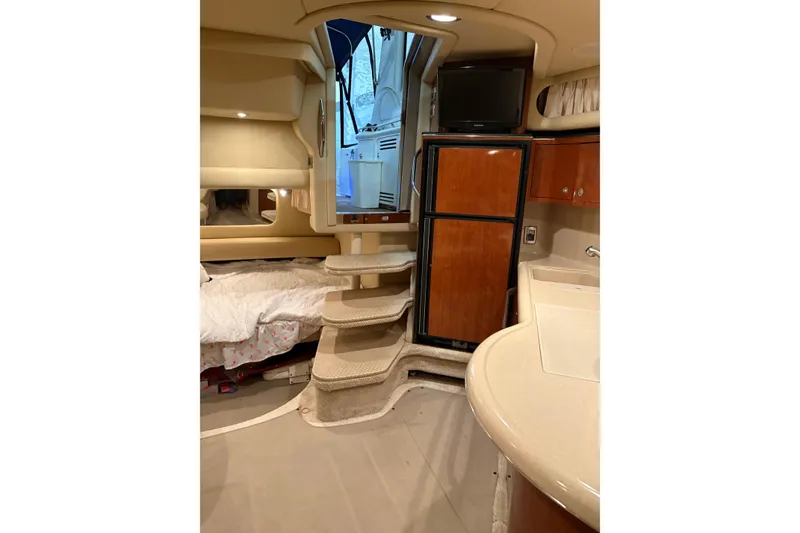Slide: The Image of Interior of 2004 Sea Ray 380 Sundancer yacht with stairs, bed, and kitchenette. - 21