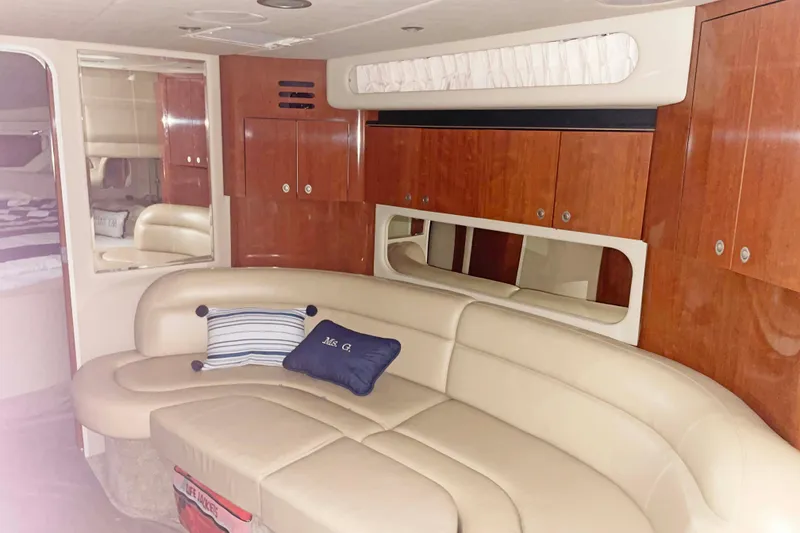 Slide: The Image of Luxurious interior of 2004 Sea Ray 380 Sundancer with leather seating and wooden cabinetry. - 25