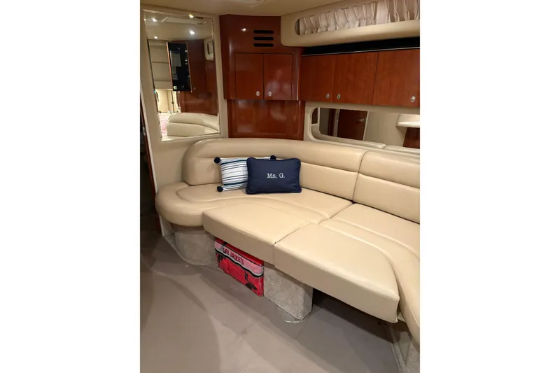Slide: The Image of Interior of 2004 Sea Ray 380 Sundancer yacht with beige seating and wooden cabinets. - 26