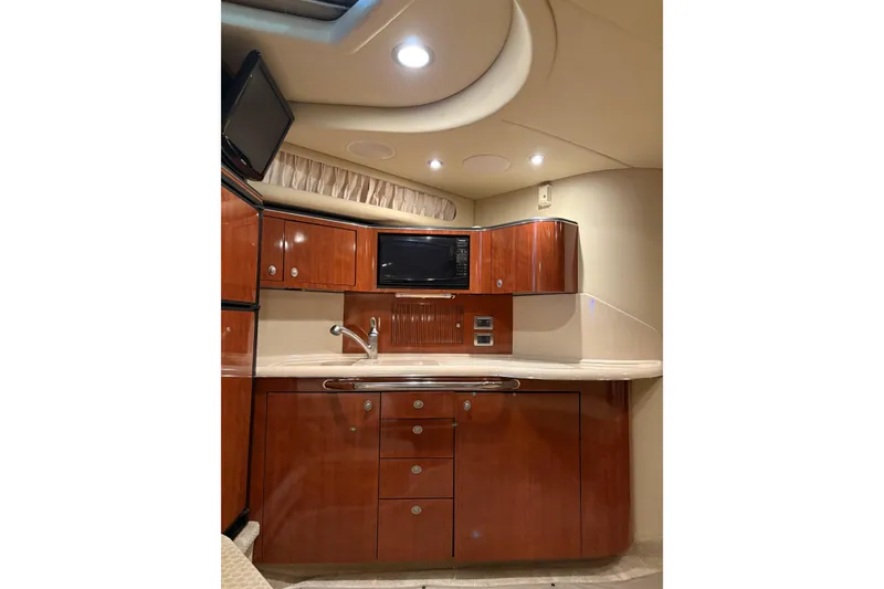 Slide: The Image of Luxurious interior of 2004 Sea Ray 380 Sundancer yacht with wood cabinetry and modern amenities. - 29