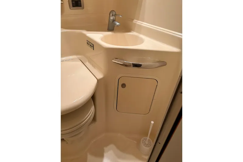 Slide: The Image of Bathroom interior of 2004 Sea Ray 380 Sundancer yacht, featuring sink and toilet. - 34