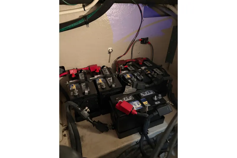 Slide: The Image of Battery compartment of a 2004 Sea Ray 380 Sundancer boat, showing multiple batteries and wiring. - 39