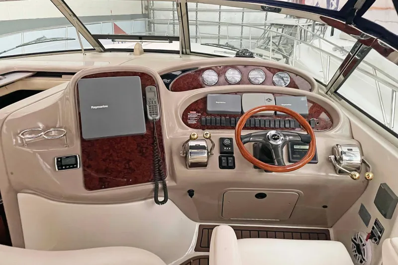 Slide: The Image of 2004 Sea Ray 380 Sundancer helm with wood accents and Raymarine electronics. - 4