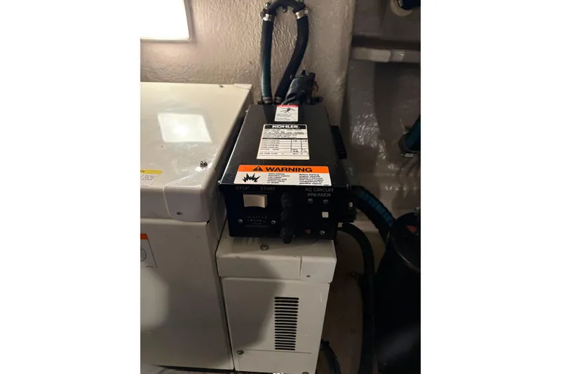 Slide: The Image of Engine room of 2004 Sea Ray 380 Sundancer with Kohler generator and warning label. - 42