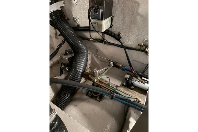 Slide: The Image of Engine compartment of a 2004 Sea Ray 380 Sundancer with visible hoses and wiring. - 44