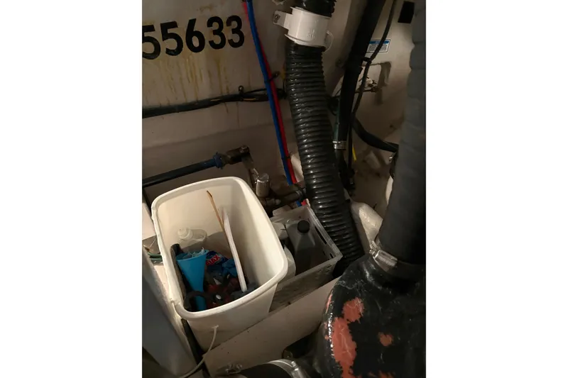 Slide: The Image of Engine compartment of a 2004 Sea Ray 380 Sundancer with maintenance supplies. - 45