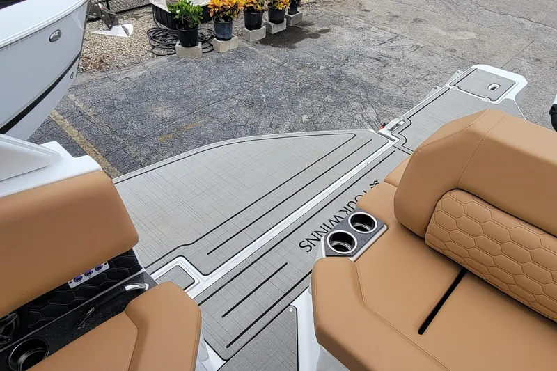 Slide: The Image of 2026 Four Winns H33 OB boat interior with tan seating and cup holders. - 18