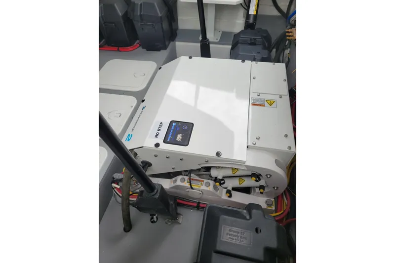 Slide: The Image of Engine compartment of 2026 Four Winns H33 OB boat, featuring mechanical components and wiring. - 26