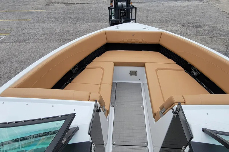 Slide: The Image of 2026 Four Winns H33 OB boat with tan seating and spacious deck layout. - 9