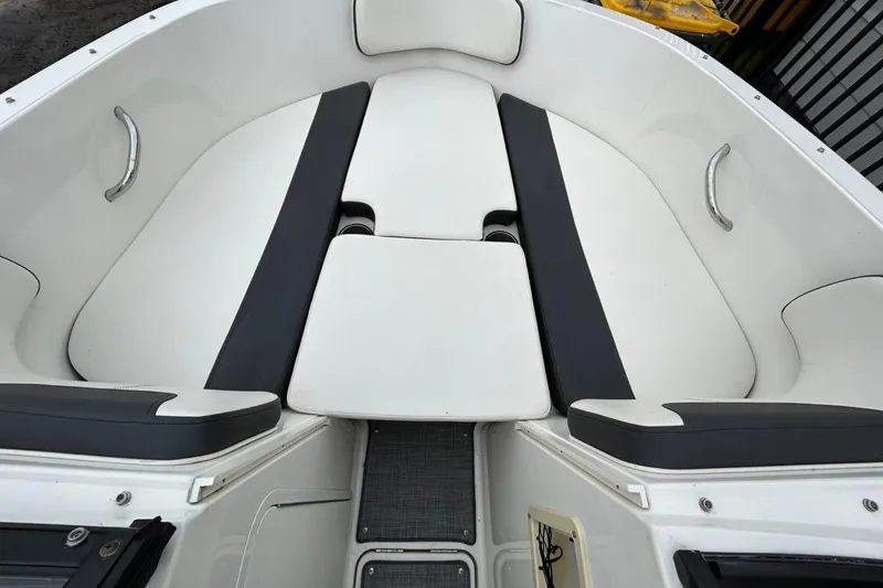 Slide: The Image of 2021 Bayliner VR4 Bowrider I/O interior with white and black seating. - 6