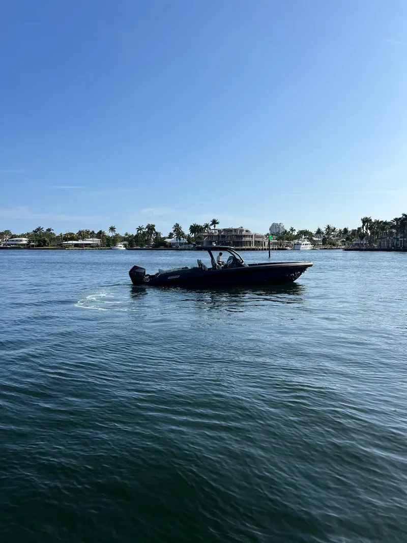 Slide: The Image of 2024 Skipper 38 boat cruising on a sunny day in calm waters. - 2