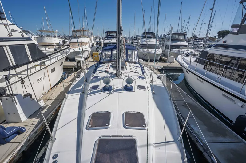 Slide: The Image of Jeanneau Sun Odyssey 45.2 sailboat, 2003 model, docked in a marina surrounded by other boats. - 19