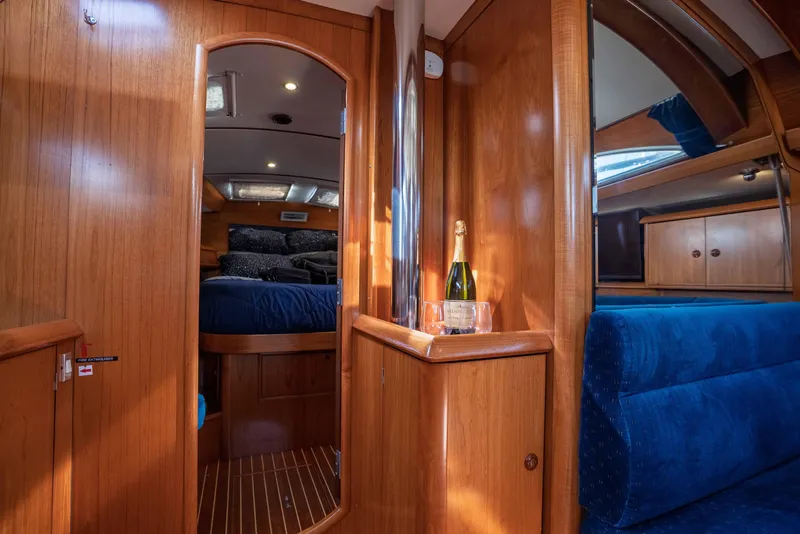 Slide: The Image of Interior of 2003 Jeanneau Sun Odyssey 45.2 yacht with wood finish and blue seating. - 41