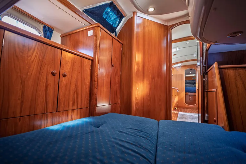 Slide: The Image of Interior of 2003 Jeanneau Sun Odyssey 45.2 yacht with wooden cabinetry and blue upholstery. - 72