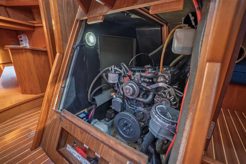 Slide: The Image of Engine compartment of 2003 Jeanneau Sun Odyssey 45.2 sailboat, showcasing detailed mechanics. - 76