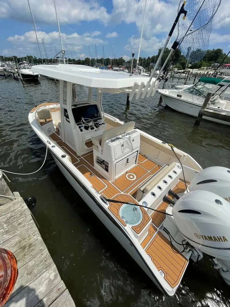 Slide: The Image of 2021 Century 2400 boat docked with Yamaha engines. - 2