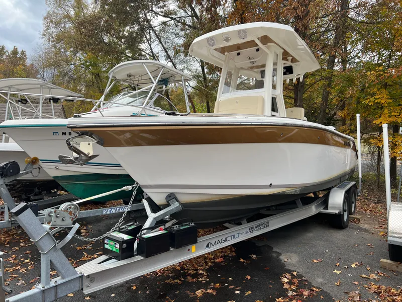 Slide: The Image of 2021 Century 2400 boat on trailer in autumn woods. - 7