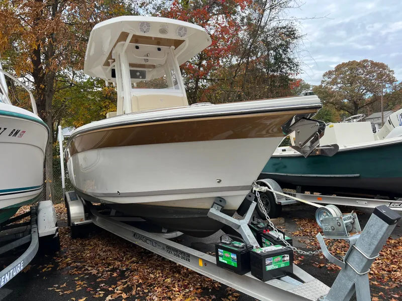 Slide: The Image of Century 2400 boat from 2021 on a trailer in autumn setting. - 8
