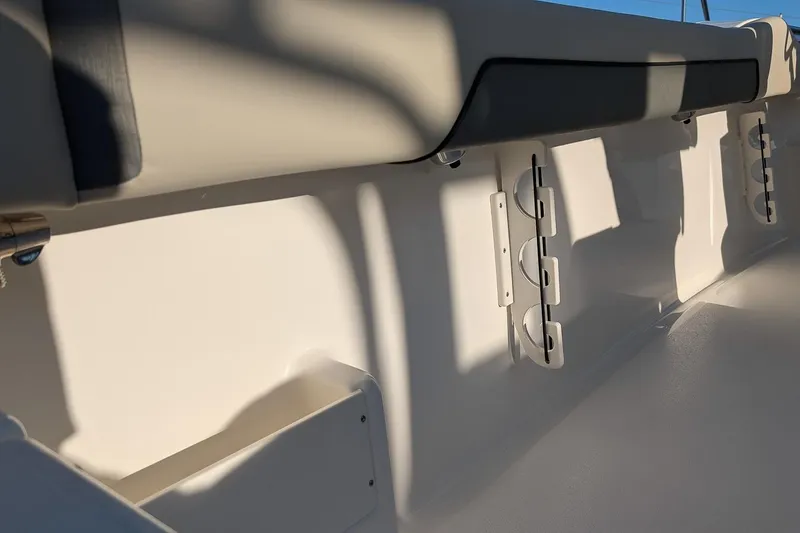 Slide: The Image of Interior view of 2026 Key West 239 FS boat, featuring rod holders and cushioned seating. - 10