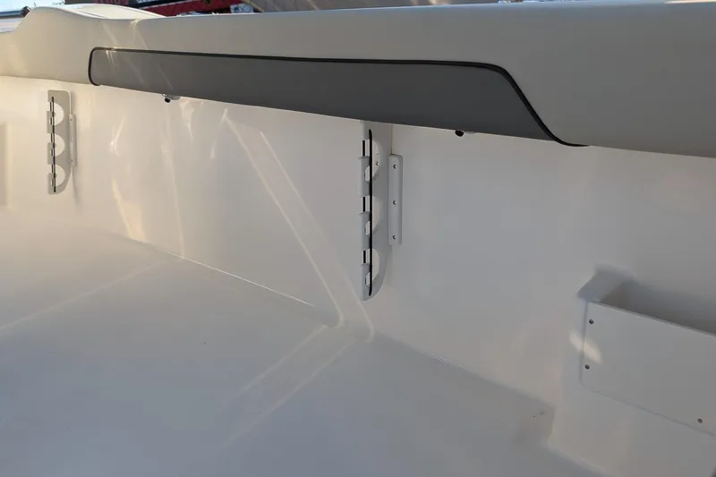 Slide: The Image of 2026 Key West 239 FS boat interior detail with rod holders and storage compartment. - 11