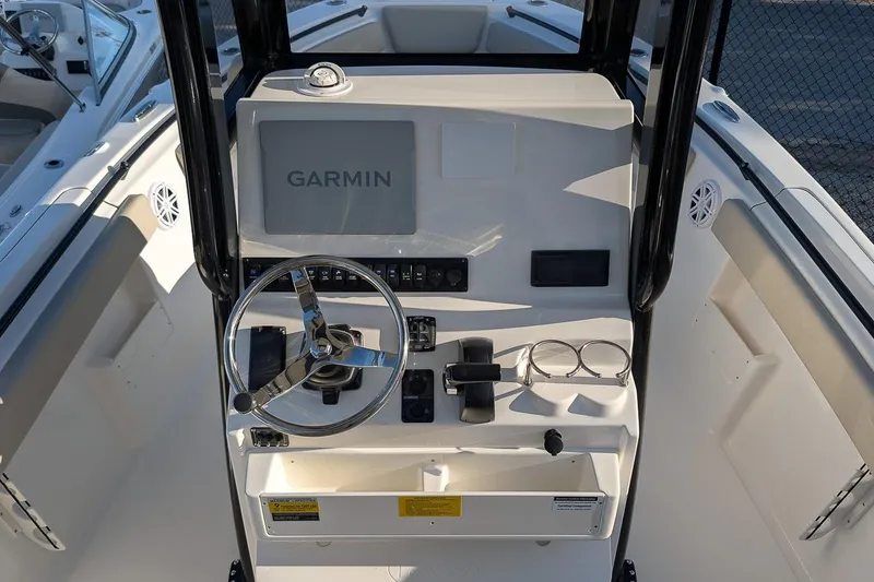 Slide: The Image of 2026 Key West 239 FS boat console with Garmin display and steering wheel. - 13