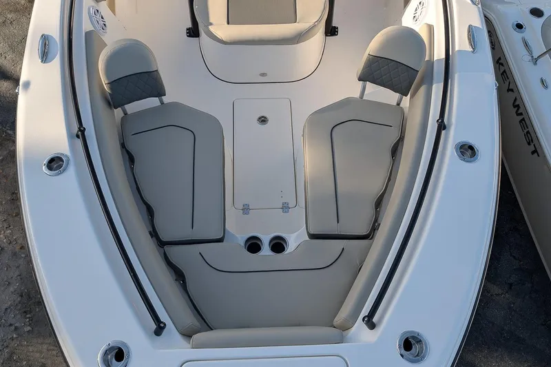 Slide: The Image of 2026 Key West 239 FS boat interior with cushioned seating and storage compartments. - 17