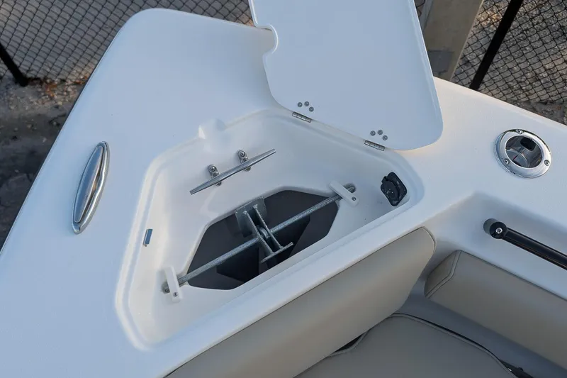 Slide: The Image of 2026 Key West 239 FS boat anchor compartment with open hatch and stainless steel hardware. - 18