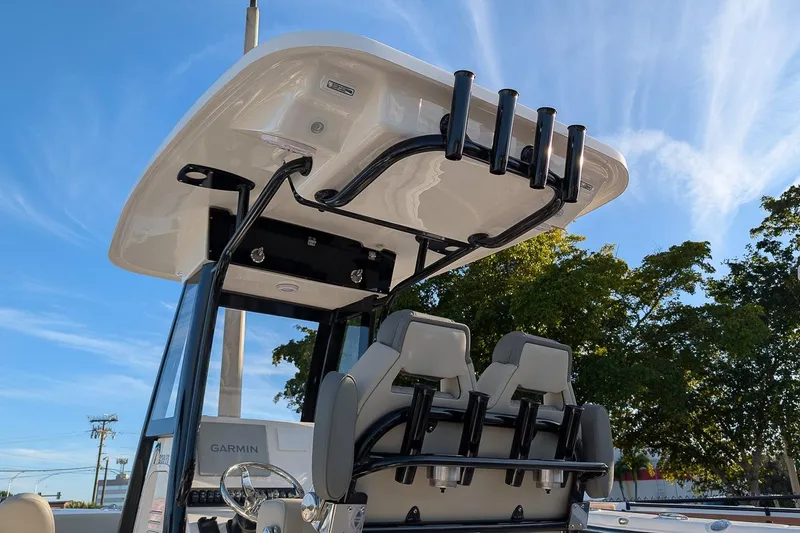 Slide: The Image of 2026 Key West 239 FS boat interior with rod holders and seating, under clear blue sky. - 19