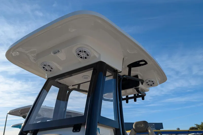 Slide: The Image of 2026 Key West 239 FS boat with T-top speakers against blue sky. - 20