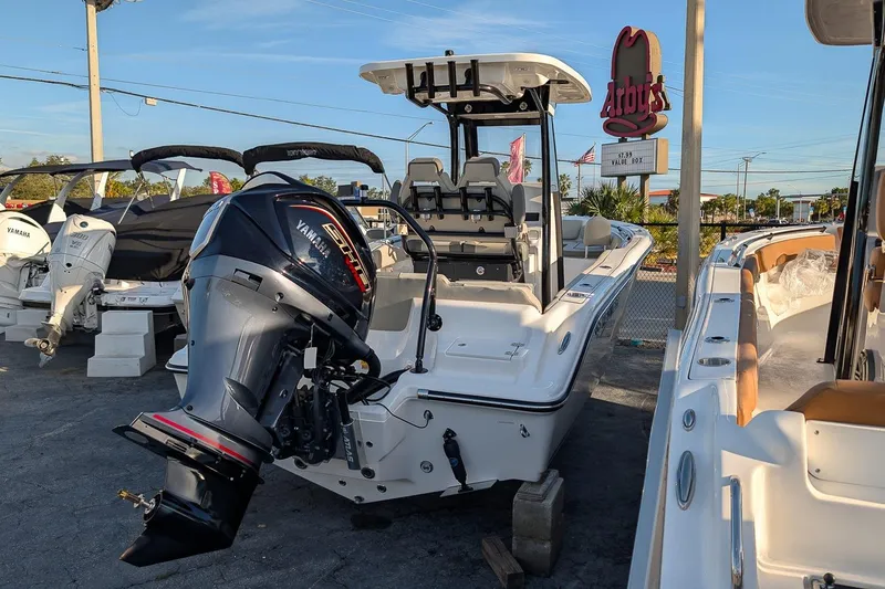 Slide: The Image of 2026 Key West 239 FS boat with Yamaha engine displayed outdoors near Arby's sign. - 3