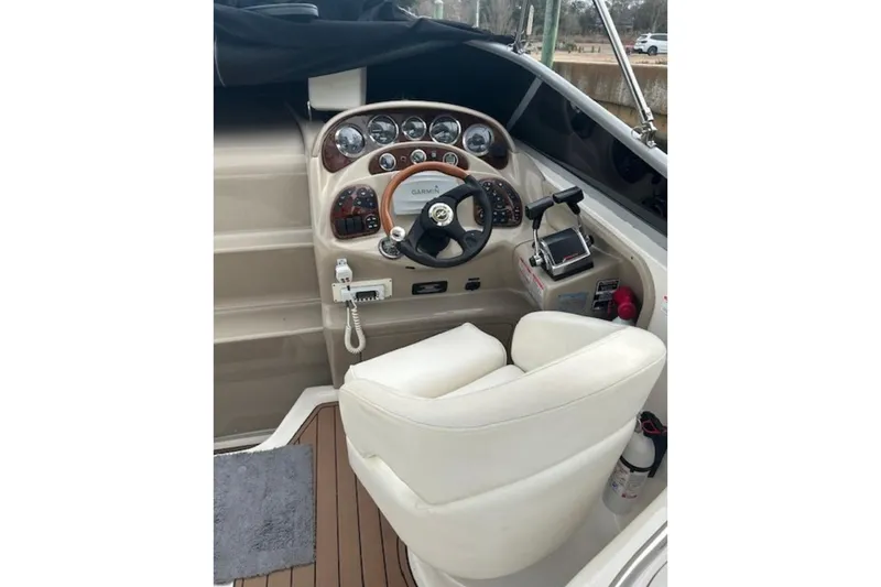 Slide: The Image of 2003 Sea Ray Sundancer 280 helm with steering wheel, gauges, and navigation equipment. - 2