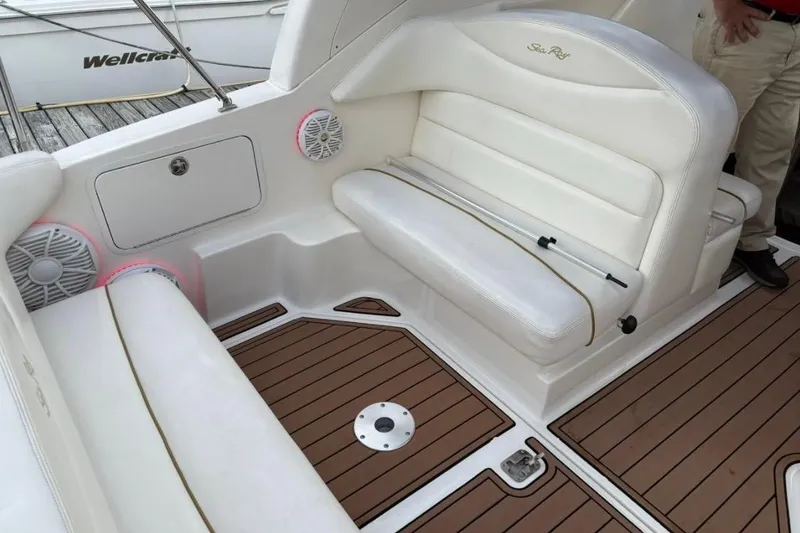Slide: The Image of 2003 Sea Ray Sundancer 280 interior with white seating and teak flooring. - 5