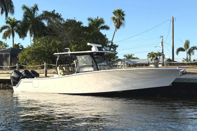 The Image of 2025 Sportsman Open 352 Center Console boat docked by palm trees. - 0