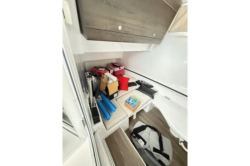 Slide: The Image of 2025 Sportsman Open 352 Center Console cabin interior with seating and storage. - 19