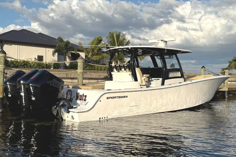 Slide: The Image of 2025 Sportsman Open 352 Center Console boat docked by waterfront home. - 3