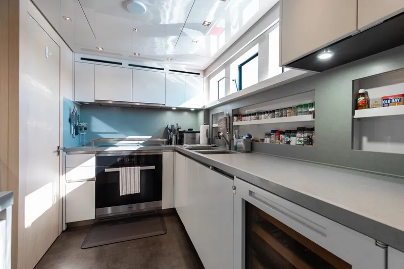 Slide: The Image of Modern kitchen interior on 2018 Sanlorenzo SL106 yacht, featuring sleek cabinetry and appliances. - 33