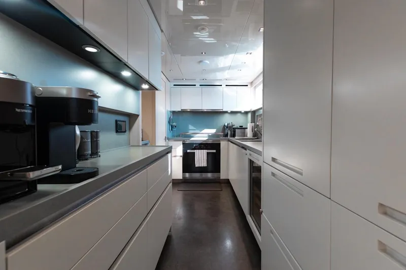 Slide: The Image of Modern kitchen interior on 2018 Sanlorenzo SL106 yacht, featuring sleek cabinetry and appliances. - 34