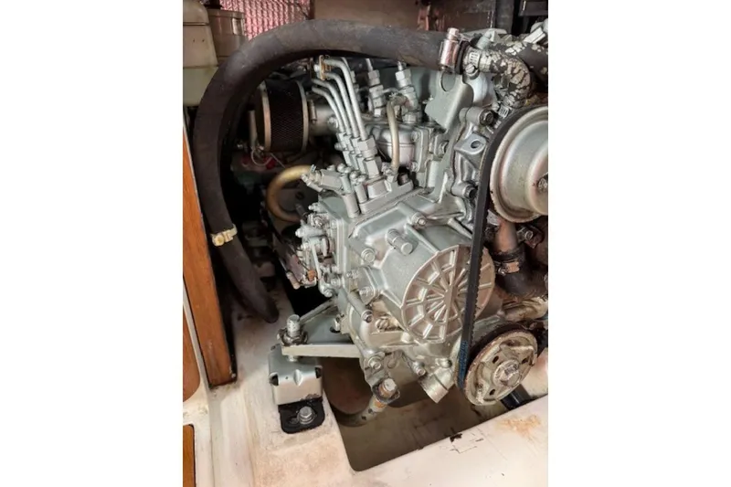 Slide: The Image of Engine of a 2004 Catalina 350 sailboat, showcasing mechanical components and hoses. - 10